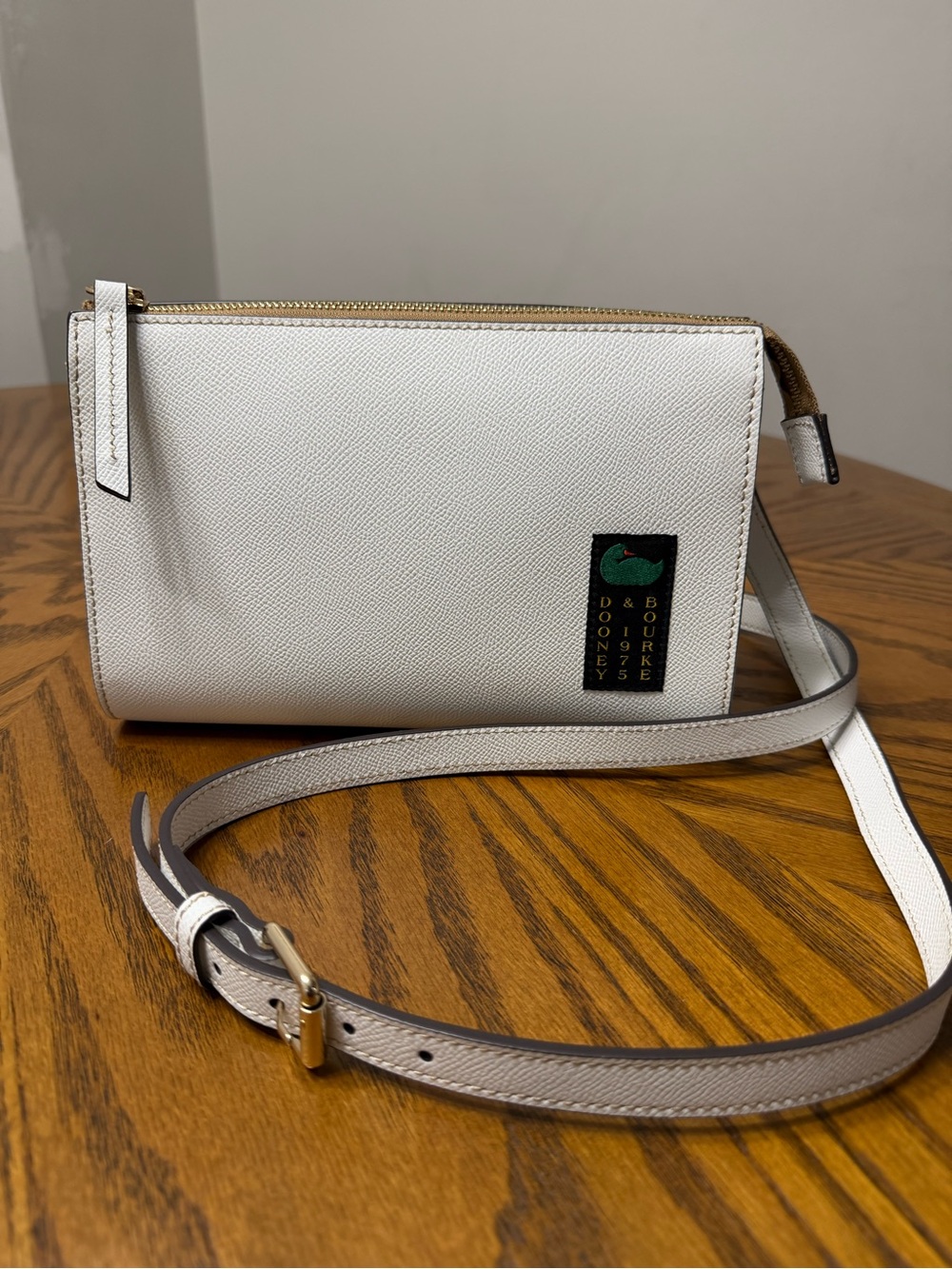 Dooney & Bourke White Crossbody with Green Logo Accent